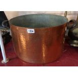 A large Victorian copper two handled saucepan with cast iron handles, beaten finish and tinned