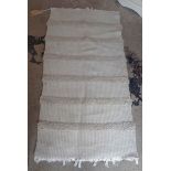 A small cream handmade rug with textured stripes