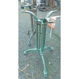 A pair of old cast iron table bases of trefoil form with later green painted finish