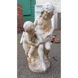 A vintage marble garden statue depicting a classical figure reading to a young child from a book -