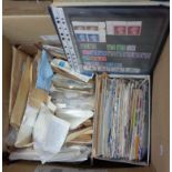 An album with hinge mounted part world stamp contents, two stock sleeves of mint GB stamps and a