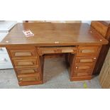 A 1.28m vintage French stained mixed wood kneehole office desk with central frieze drawer,