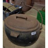 A Cannon Hollow Ware Co. Ltd. 3 1/2 gallon cast iron cooking pot with pressed tin lid and handle for