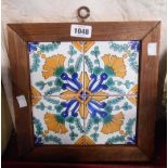 A framed decorative four tile panel