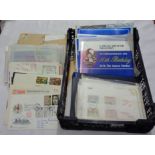 A crate containing a collection of mint GB and Commonwealth royal commemorative stamps, mainly in