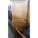 A 20th Century two part pitch pine corner cupboard, the upper cupboard with dentil cornice, each