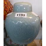 A 20th Century Chinese porcelain ginger jar and lid with incised decoration and a celadon glaze