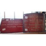 A small old curved red enamel warning sign with white lettering for The East Devon Electricity Co.
