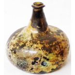 An 18th Century onion bottle with short neck and kick-in base with iridescent dug-up patina