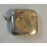 A silver flip-top vesta case of curved form with engraved initials - dents