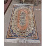 A handmade silk rug with central foliate cartouche with floral and geometric borders