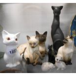 Eight assorted cat figurines including Beswick matt glazed Siamese Model 1559, Royal Worcester