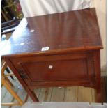 An Edwardian mahogany and strung pot cupboard with panelled door, set on square tapered legs with