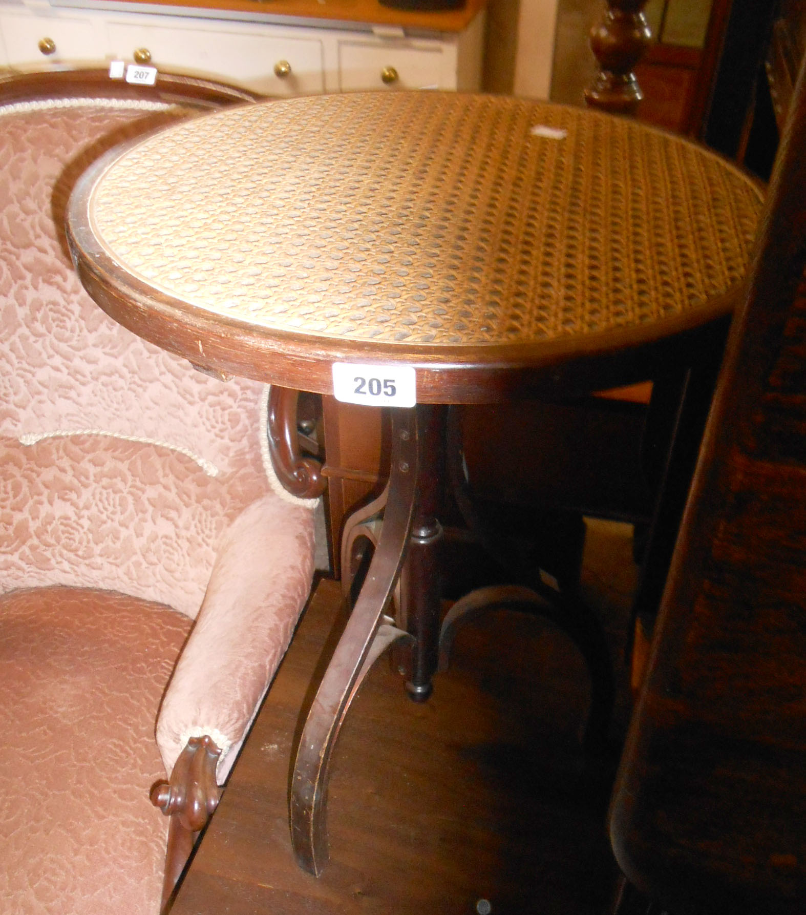 A reproduction bentwood tripod table with rattan top