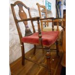 An Chippendale style mahogany framed elbow chair with shaped splat back and old rose upholstered