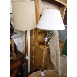 An oak standard lamp - sold with a modern brushed silvered metal similar - both with shades