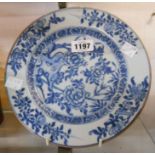 An antique Chinese plate hand painted in blue with floral sprays
