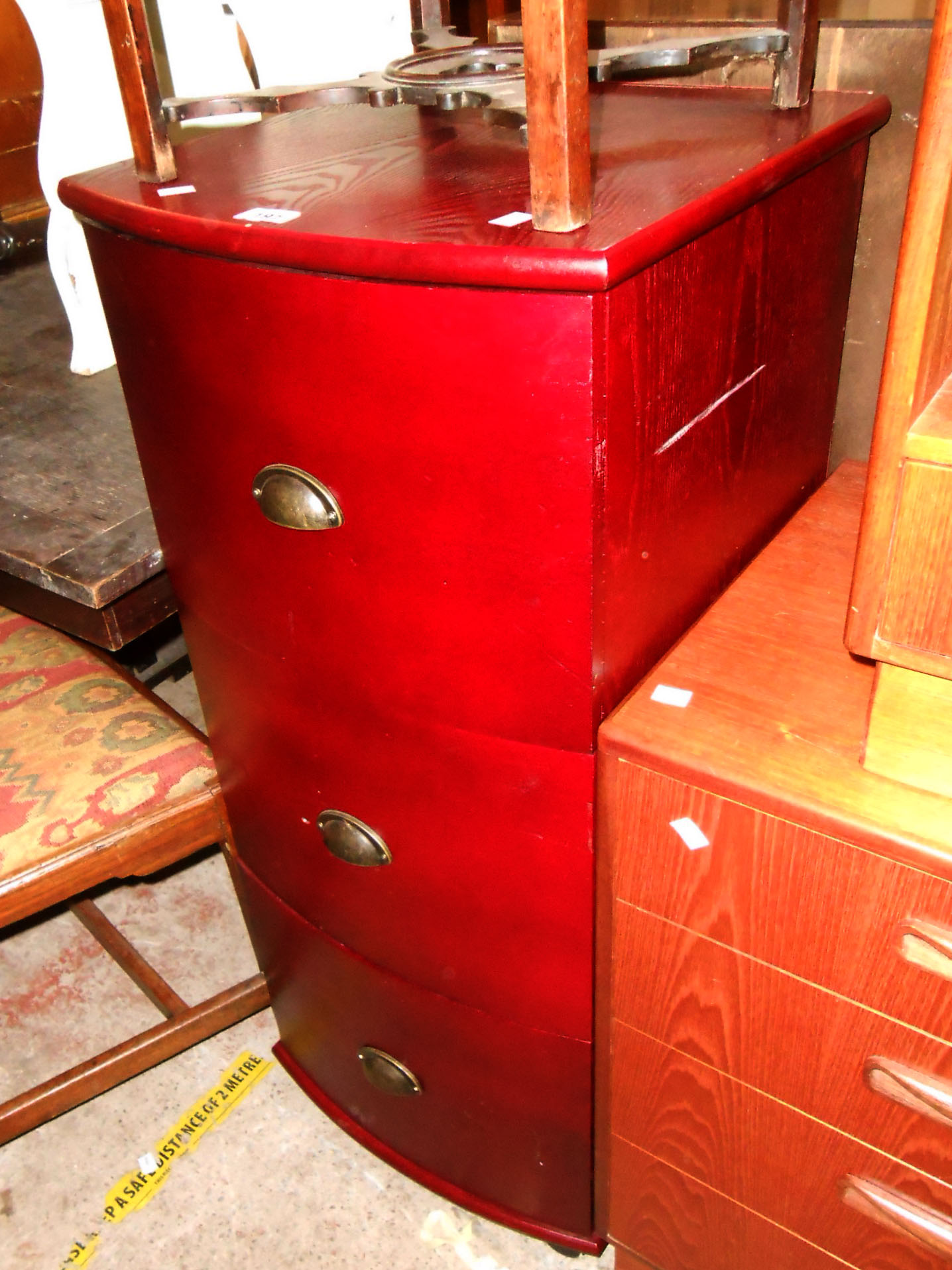 A 44cm modern stained wood bow front filing chest of three long drawers