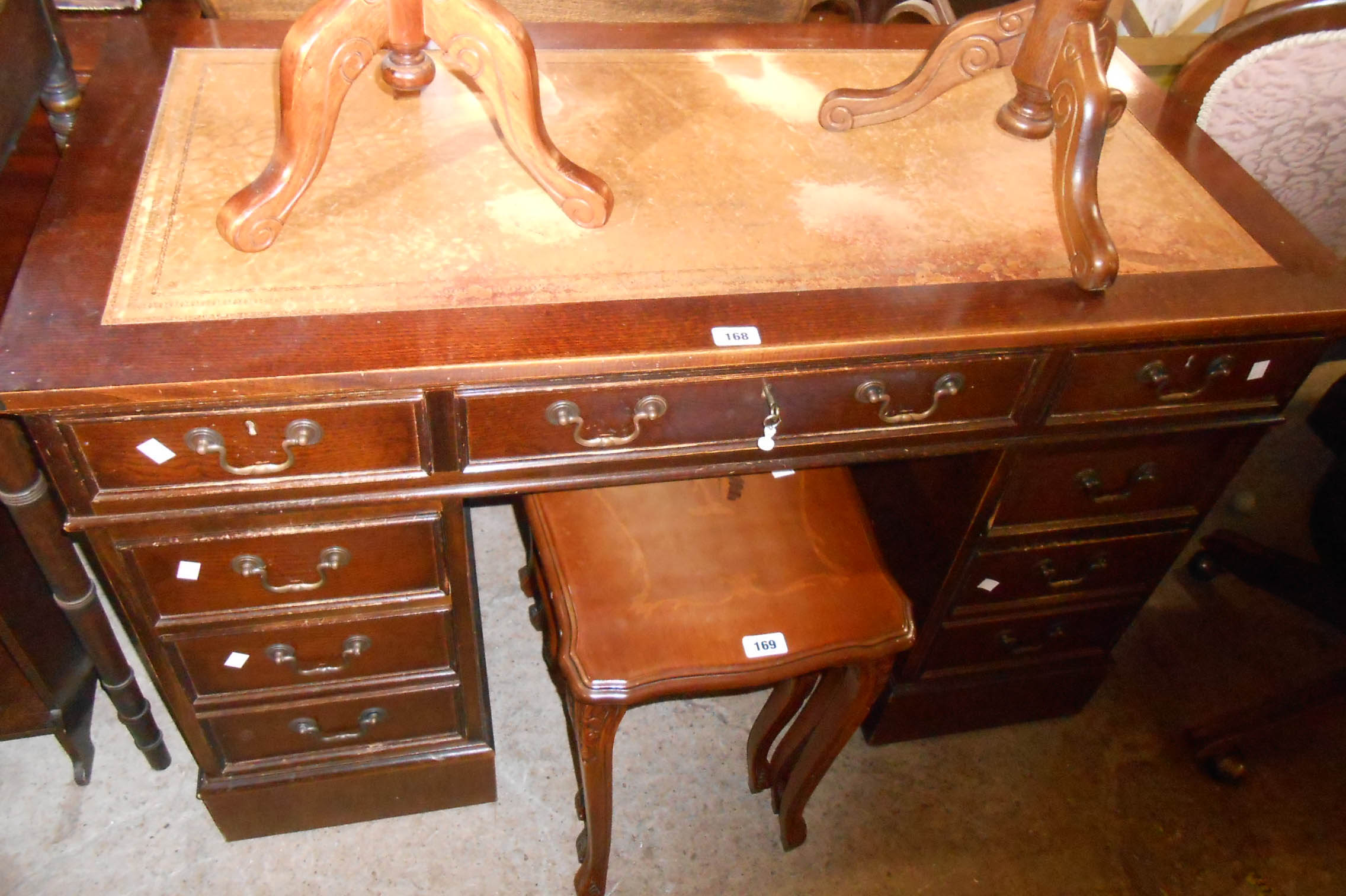 A 1.2m reproduction stained oak twin pedestal desk with leather inset top, three frieze drawers