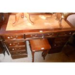 A 1.2m reproduction stained oak twin pedestal desk with leather inset top, three frieze drawers