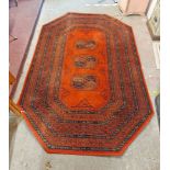An octagonal modern machine made Belgian rug with central repeat shield design and multiple floral