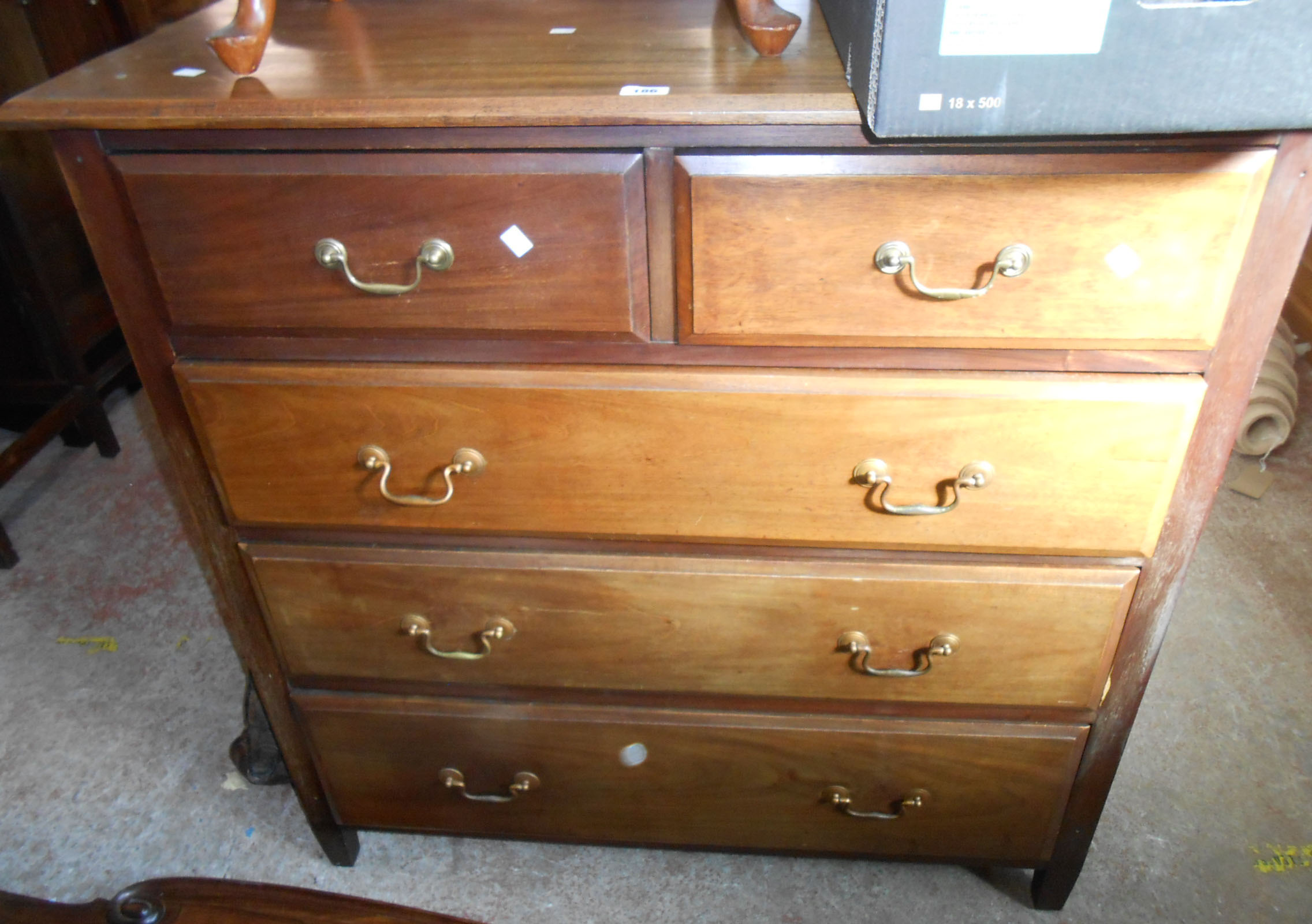A 1.13m vintage mahogany chest of two short and three long graduated drawers, set on short tapered
