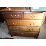 A 1.13m vintage mahogany chest of two short and three long graduated drawers, set on short tapered