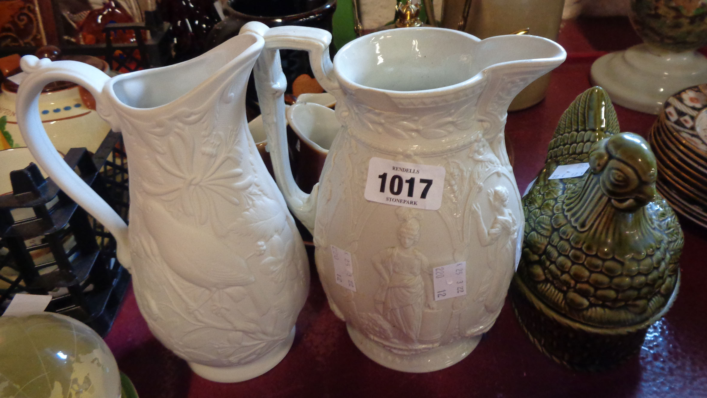 A Victorian Parian relief moulded jug (a/f) - sold with a similar modern Portmeirion example and a