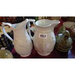 A Victorian Parian relief moulded jug (a/f) - sold with a similar modern Portmeirion example and a