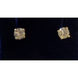 A pair of yellow metal mounted diamond solitaire stud earrings - boxed