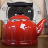 A modern Le Creuset kettle in red enamel finish