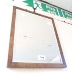 A small mahogany framed bevelled oblong wall mirror