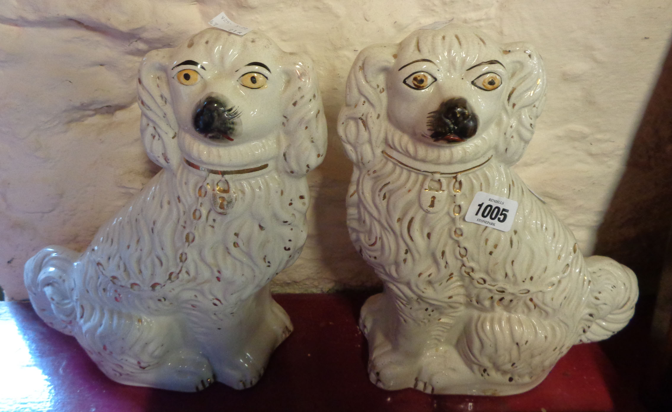 A pair of Victorian Staffordshire comforter spaniels with gilt and painted highlighting