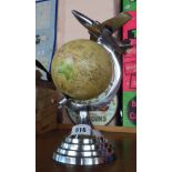 A modern Art Deco style globe with aeroplane finial