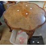 A 66cm walnut quarter veneered tea table with petal shaped top, set on cabriole legs with pad feet