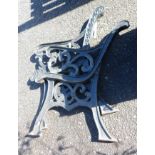 A pair of modern painted cast iron bench ends