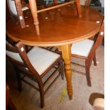 A 1.06m diameter late 20th Century reproduction parquetry style top dining table, set on turned