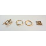 A 22ct. gold wedding band, a marked 18ct. and PLAT tiny diamond solitaire ring, a 9c wishbone