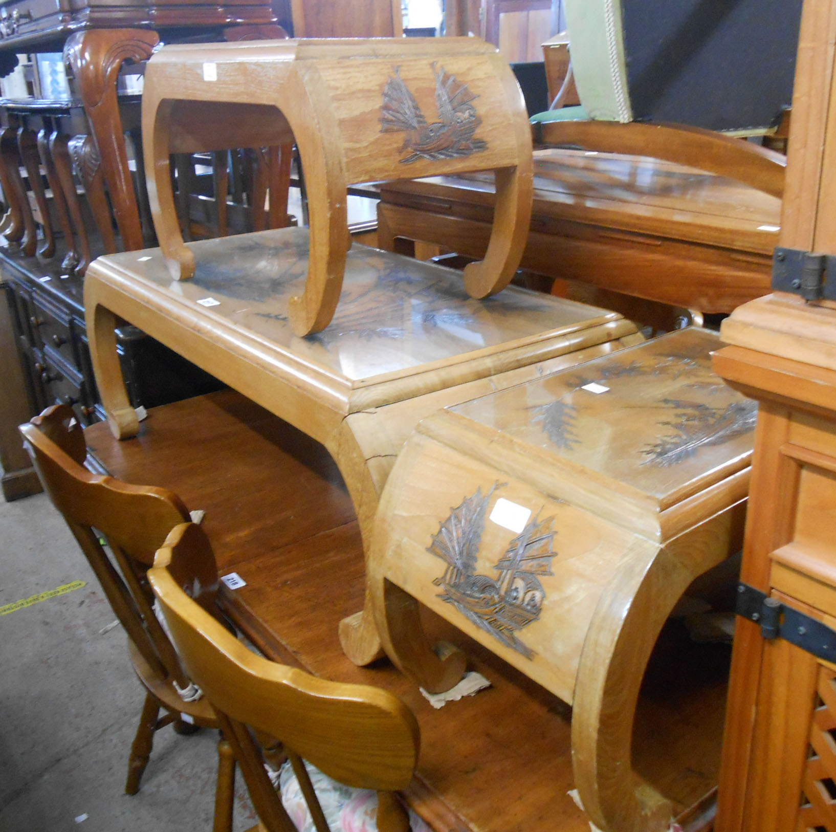 A 1.03m late Chinese hardwood coffee table with carved decoration under glass, set on opium table