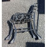 A pair of painted cast iron bench ends and connecting rod