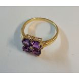 A 375 gold ring, set with four amethysts interspersed with tiny diamonds - boxed