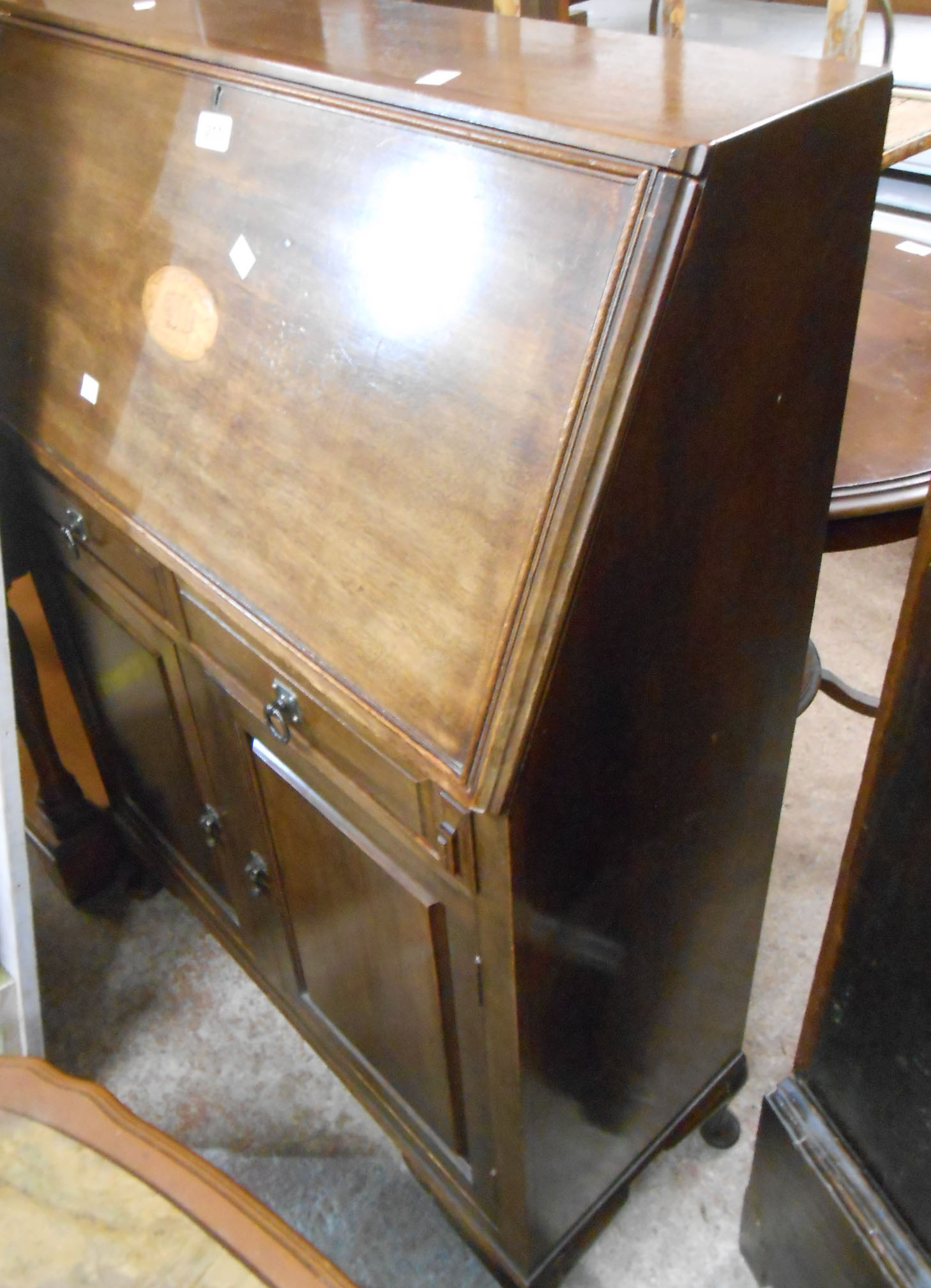 A 77cm early 20th Century mahogany bureau with shell motif to fall, part fitted interior, two