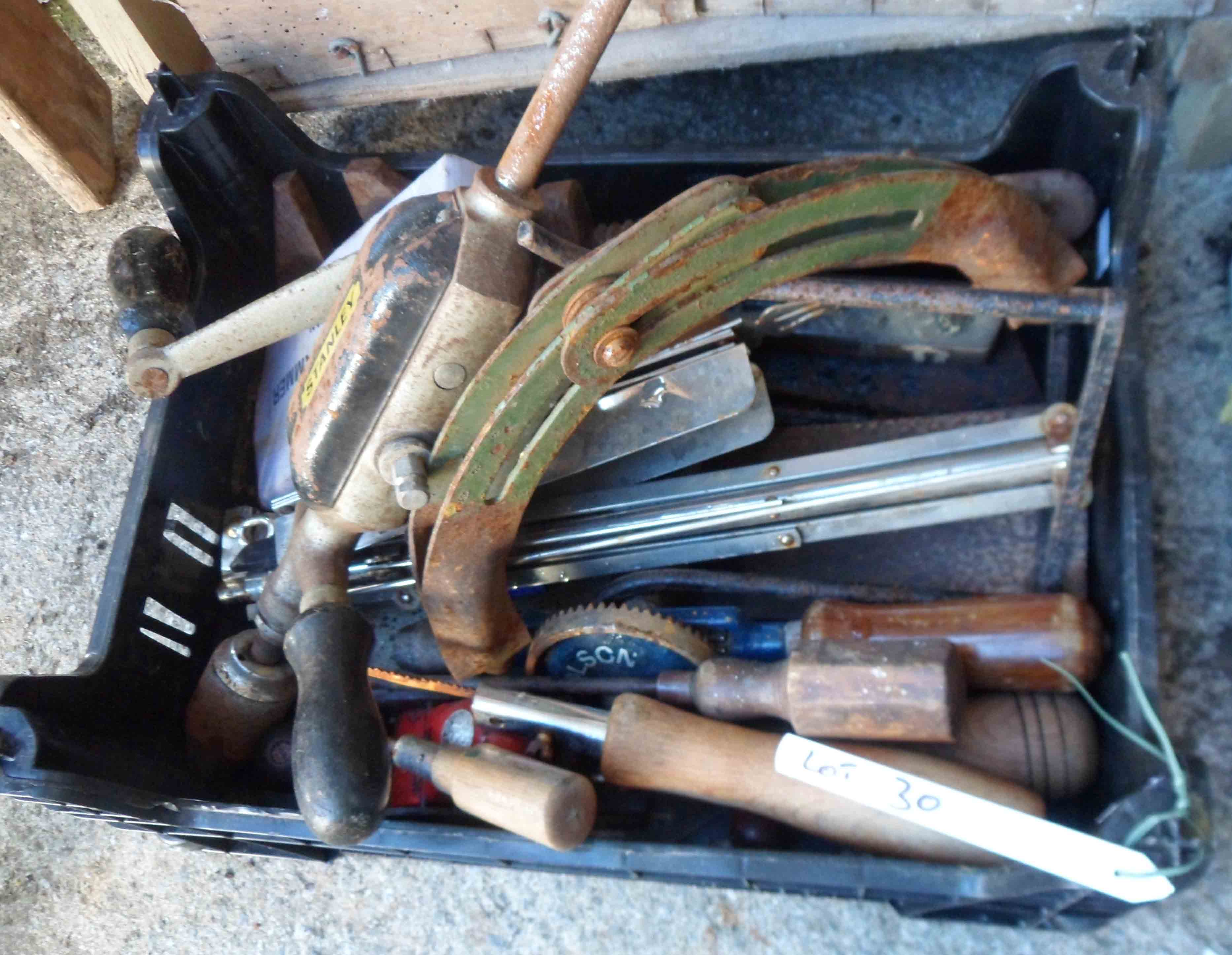 A crate containing a quantity of assorted tools including Stanley hand drill, screwdrivers,