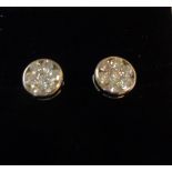 A pair of high carat white metal stud earrings with marked 18k butterflies, each set with a