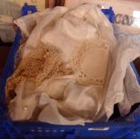 A crate containing a small quantity of lace, crochet work and a lady's slip