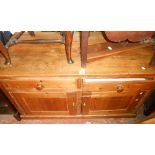 A 1.37m Victorian pine dresser base with two frieze drawers and pair of panelled cupboard doors