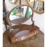 A Victorian platform swing dressing table mirror with oval plate, set on a base with three frieze