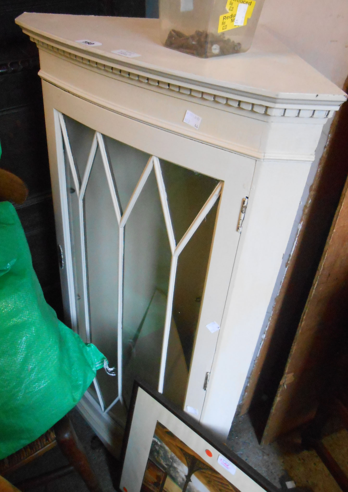 A 58cm vintage later painted corner cabinet with glazed panel door, set on bracket base