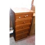 A 50cm G-Plan teak effect chest of five long drawers, set on plinth base