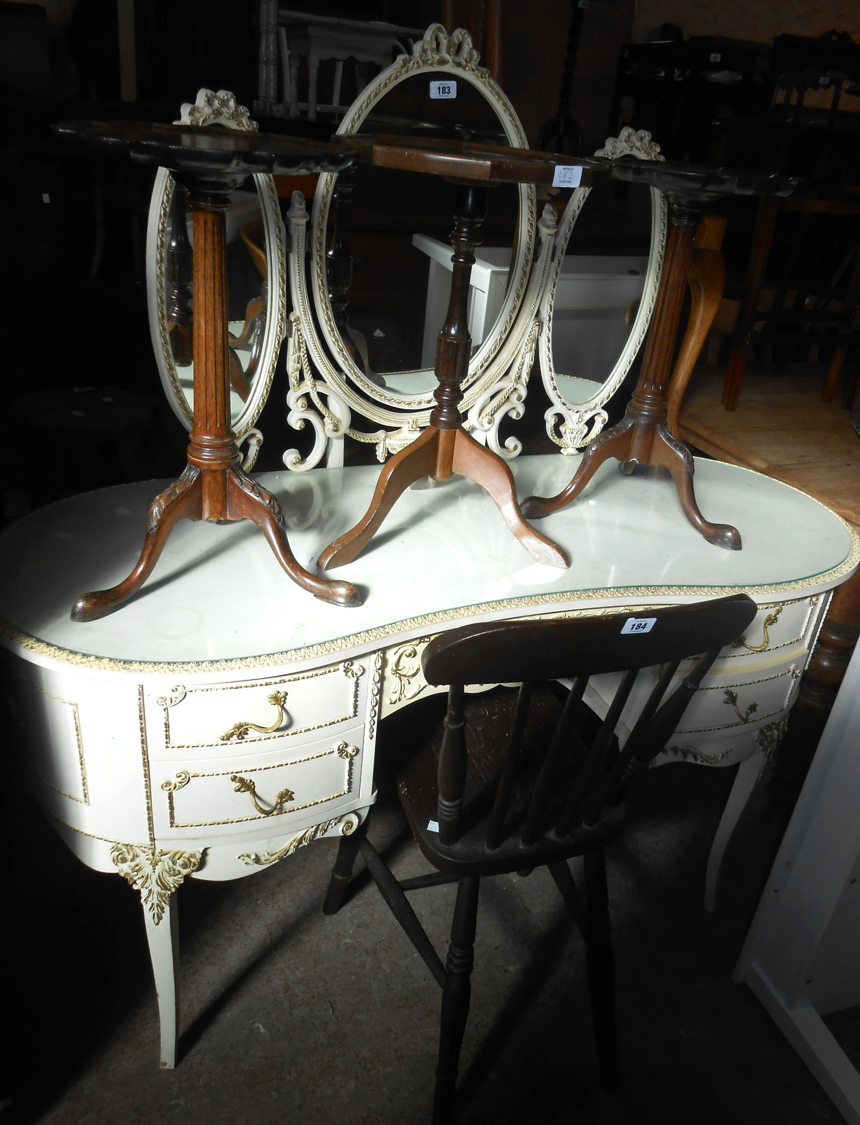 A 1.35m vintage French style white painted and parcel gilt kidney shaped dressing table with